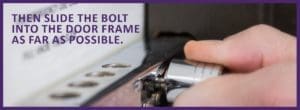 Hands demonstrating how to slide the bolt into the door frame as far as possible to secure the classroom door