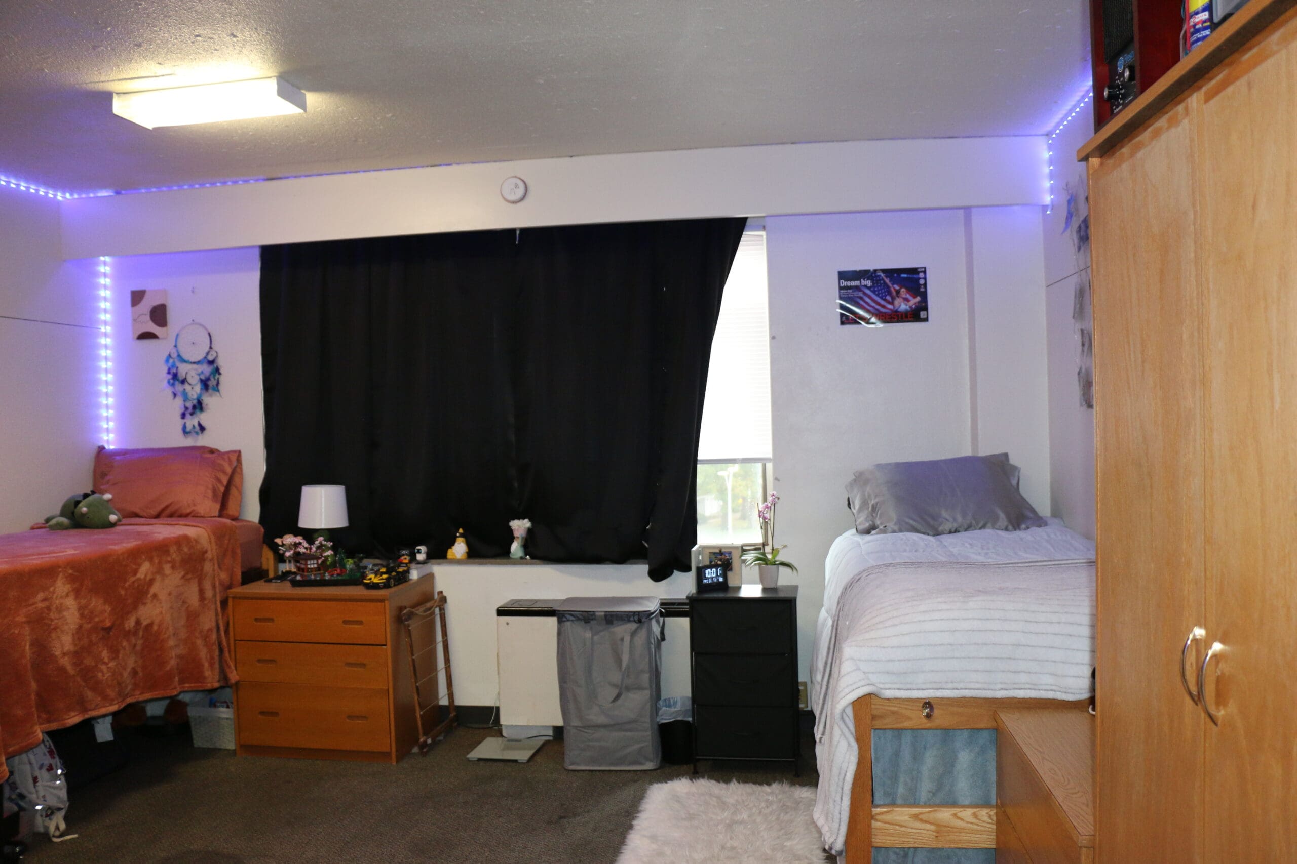 Campus housing room with bed, desk, and personal living essentials