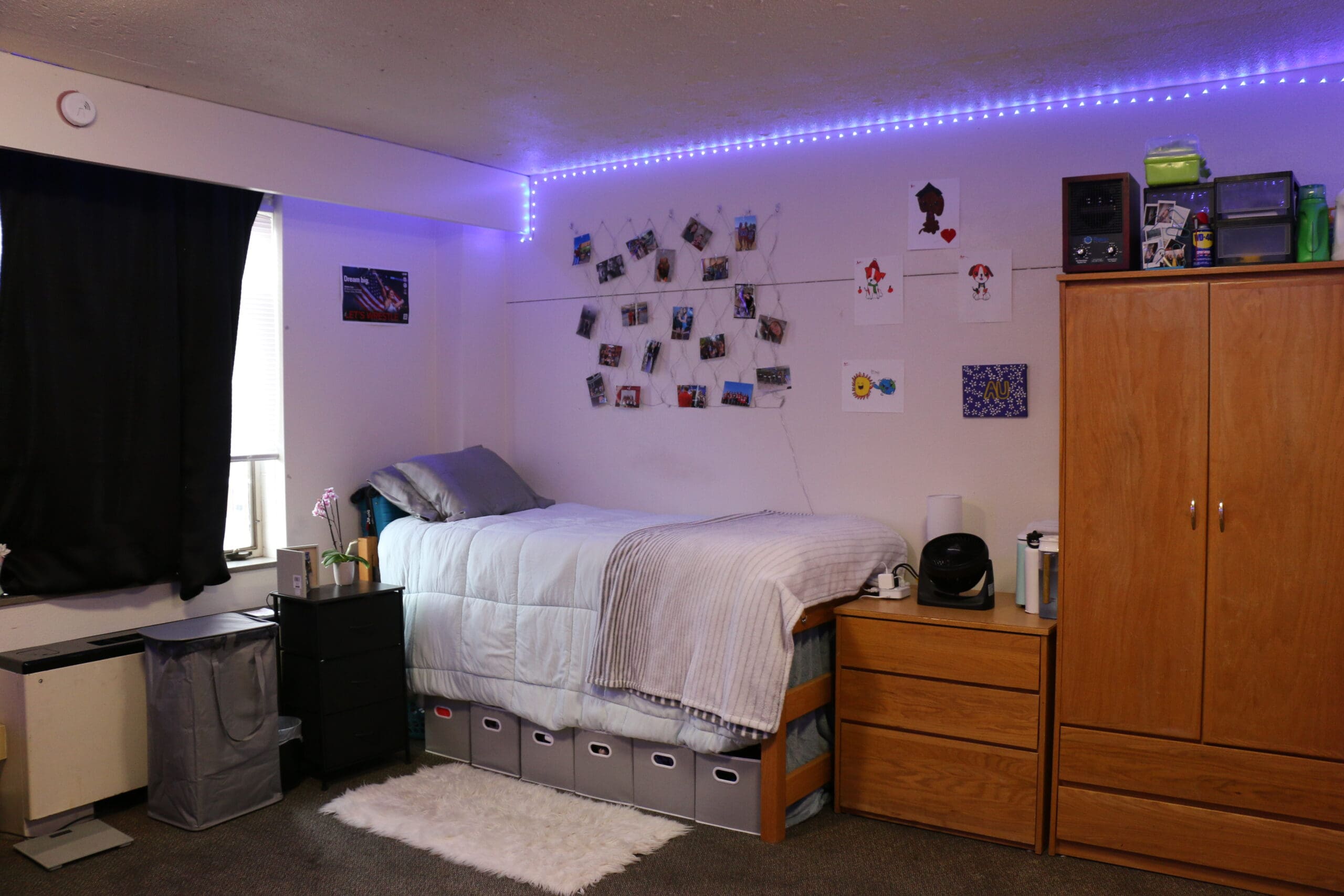Campus housing room with bed, desk, and personal living essentials