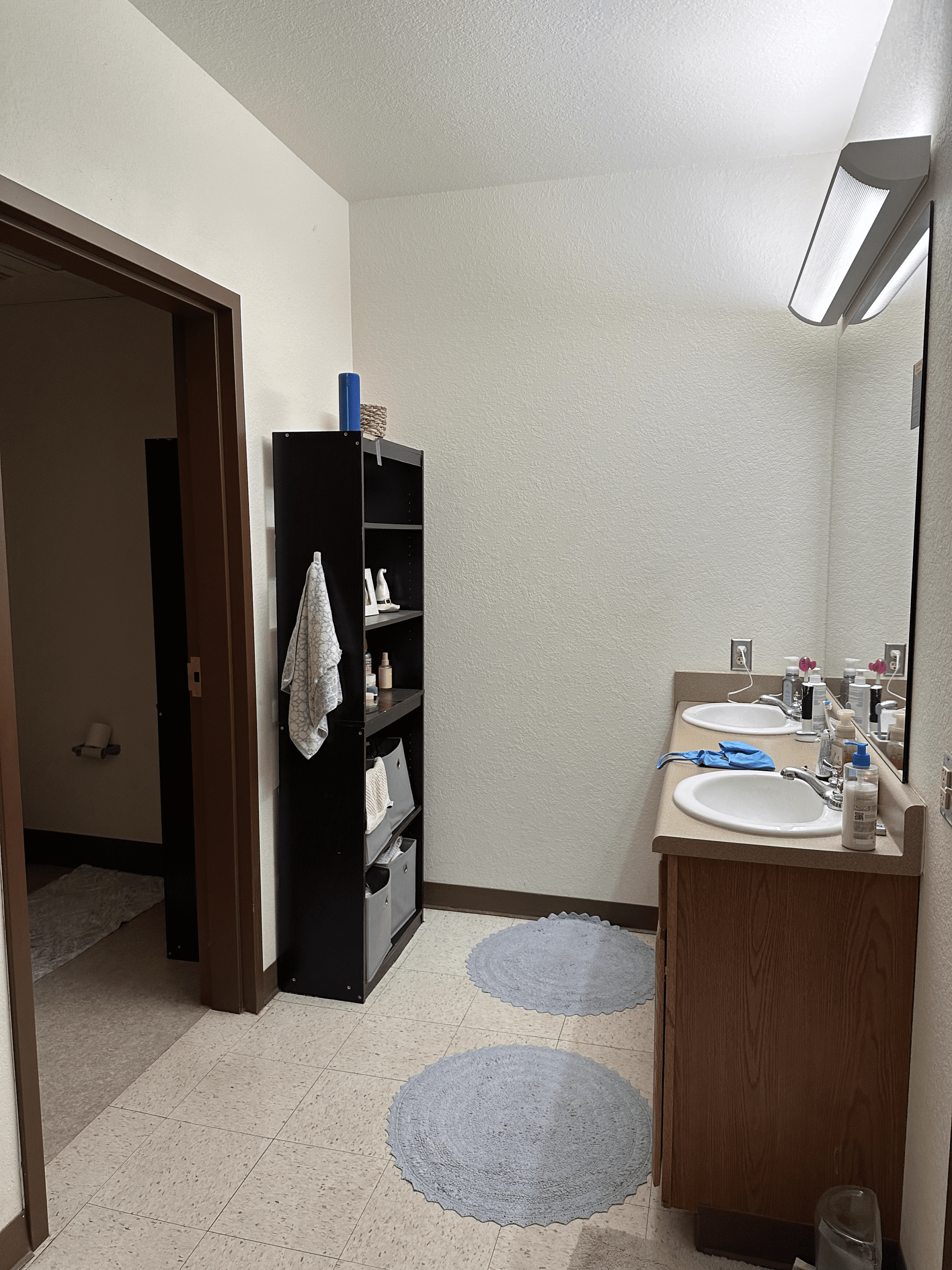 Student living space with bed, study desk, and natural light from window
