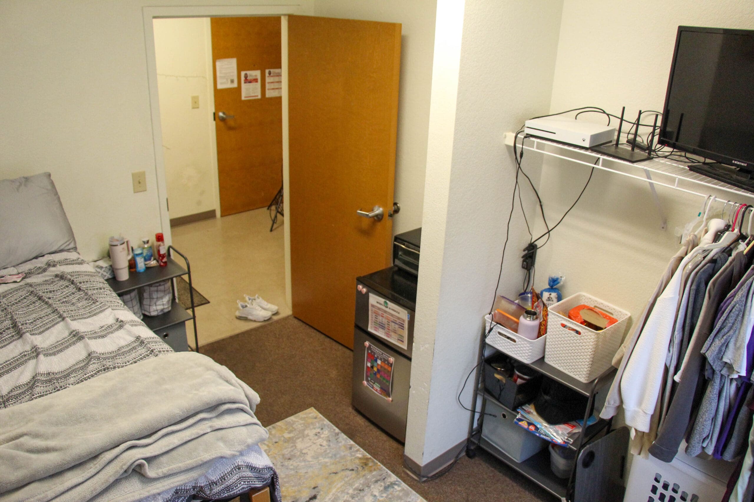Wylie Hall suite bedroom with desk, computer, and standard furnishings