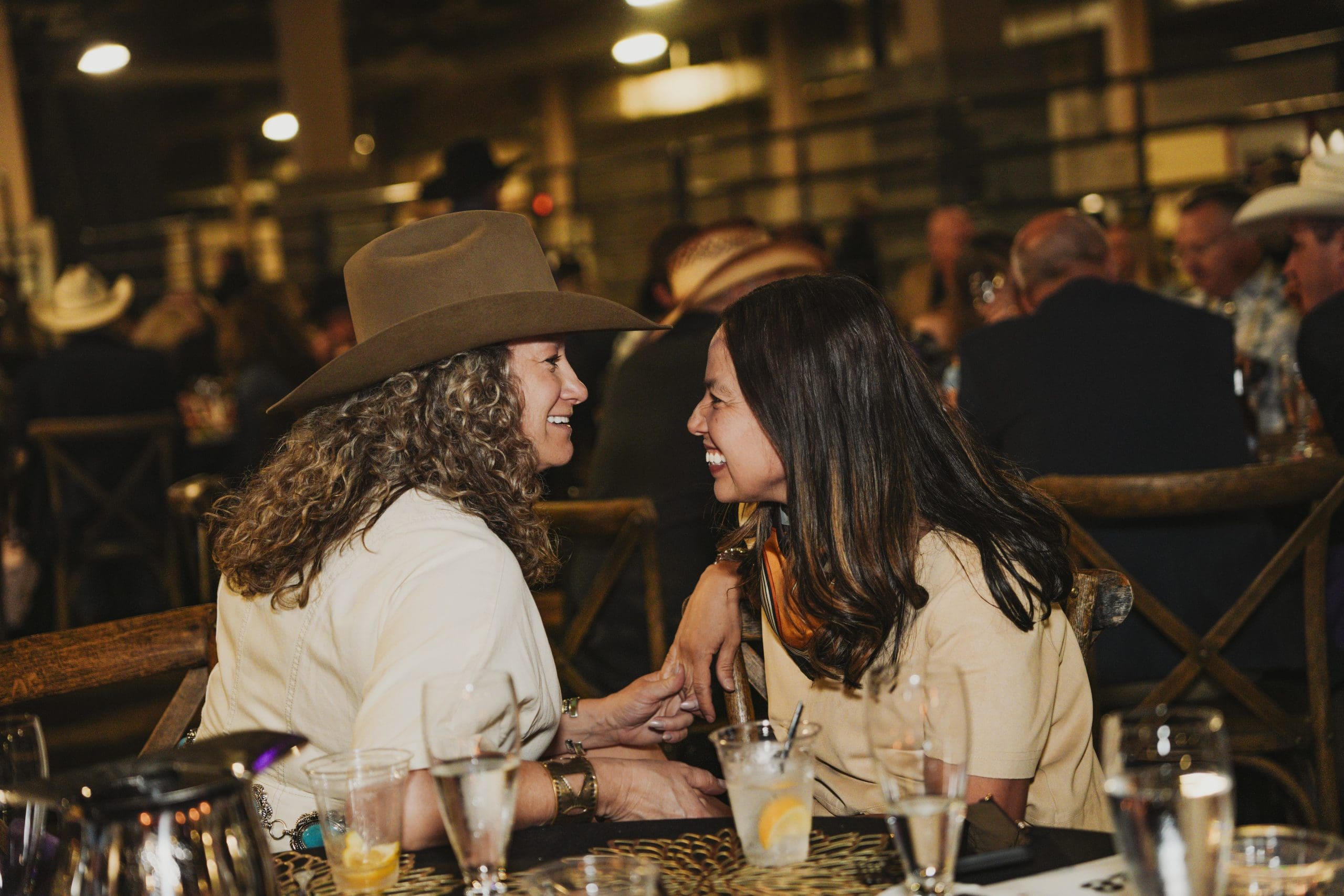 Two women in western attire conversing at the Avila University Steer Dinner