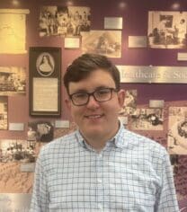 Tom Pfeifer in front of the History Wall in the Hooley-Bundschu Library & Learning Commons at Avila University.