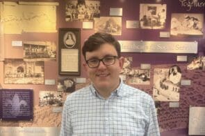 Tom Pfeifer in front of the History Wall in the Hooley-Bundschu Library & Learning Commons at Avila University.