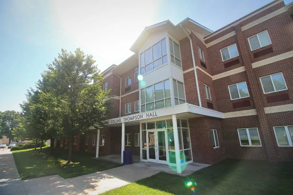 Avila University campus building exterior with brick facade and glass entrance surrounded by trees
