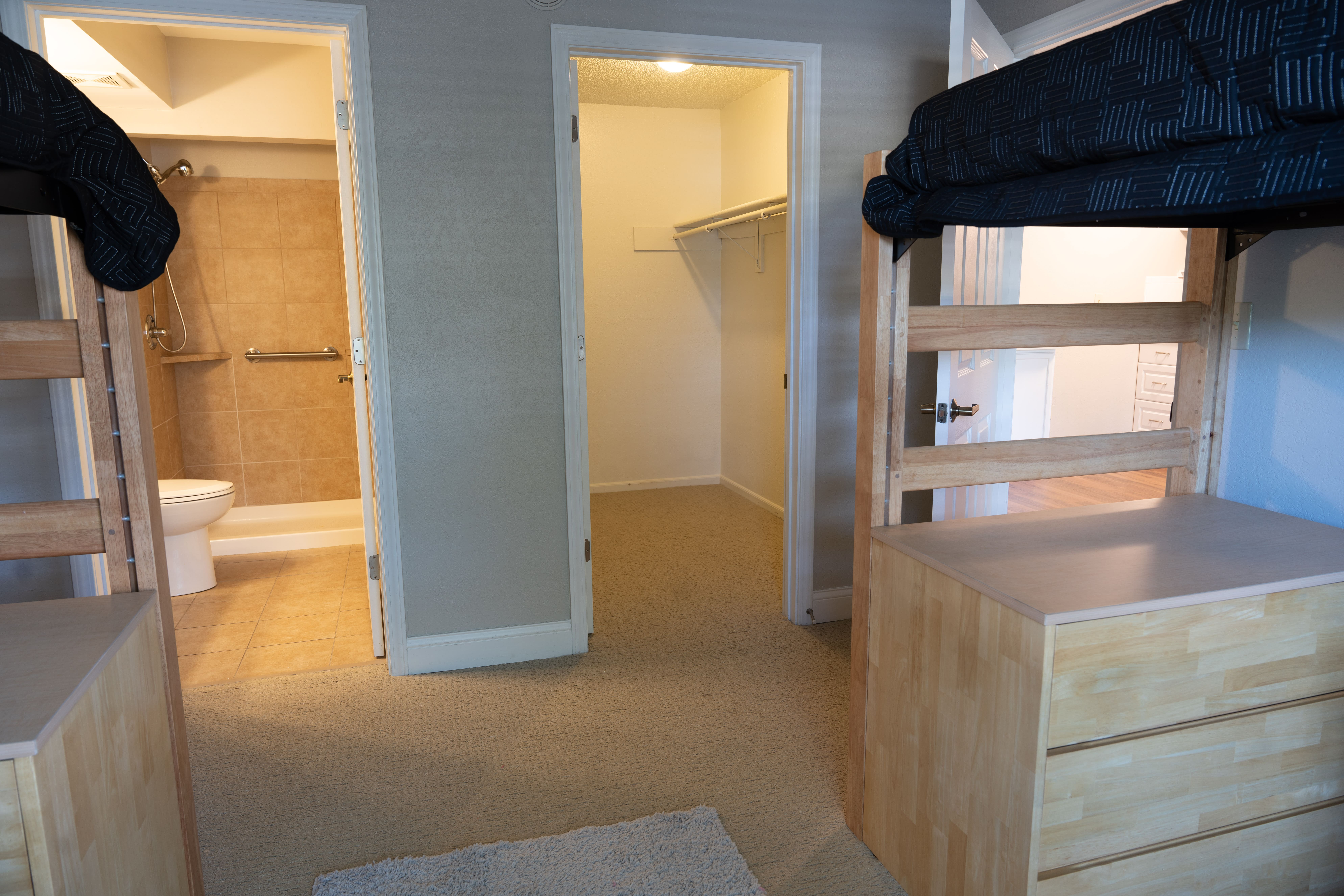 Campus residence hall room with neatly arranged furniture.