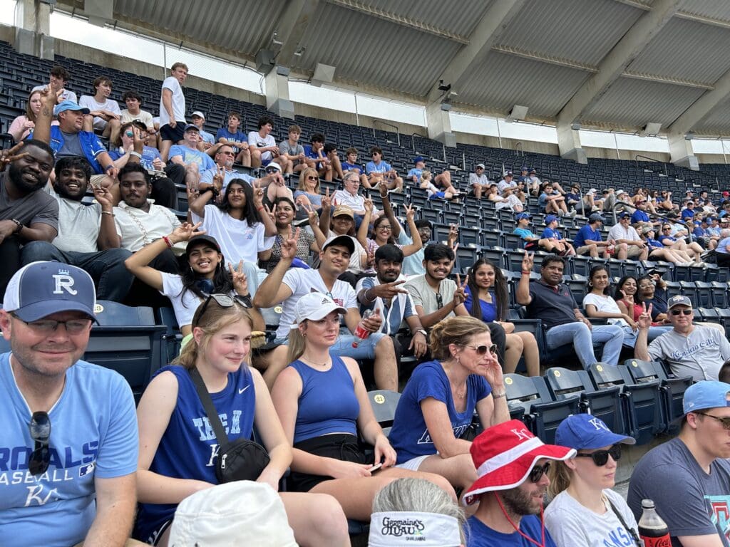 students cheering at a Kansas City Royals baseball game